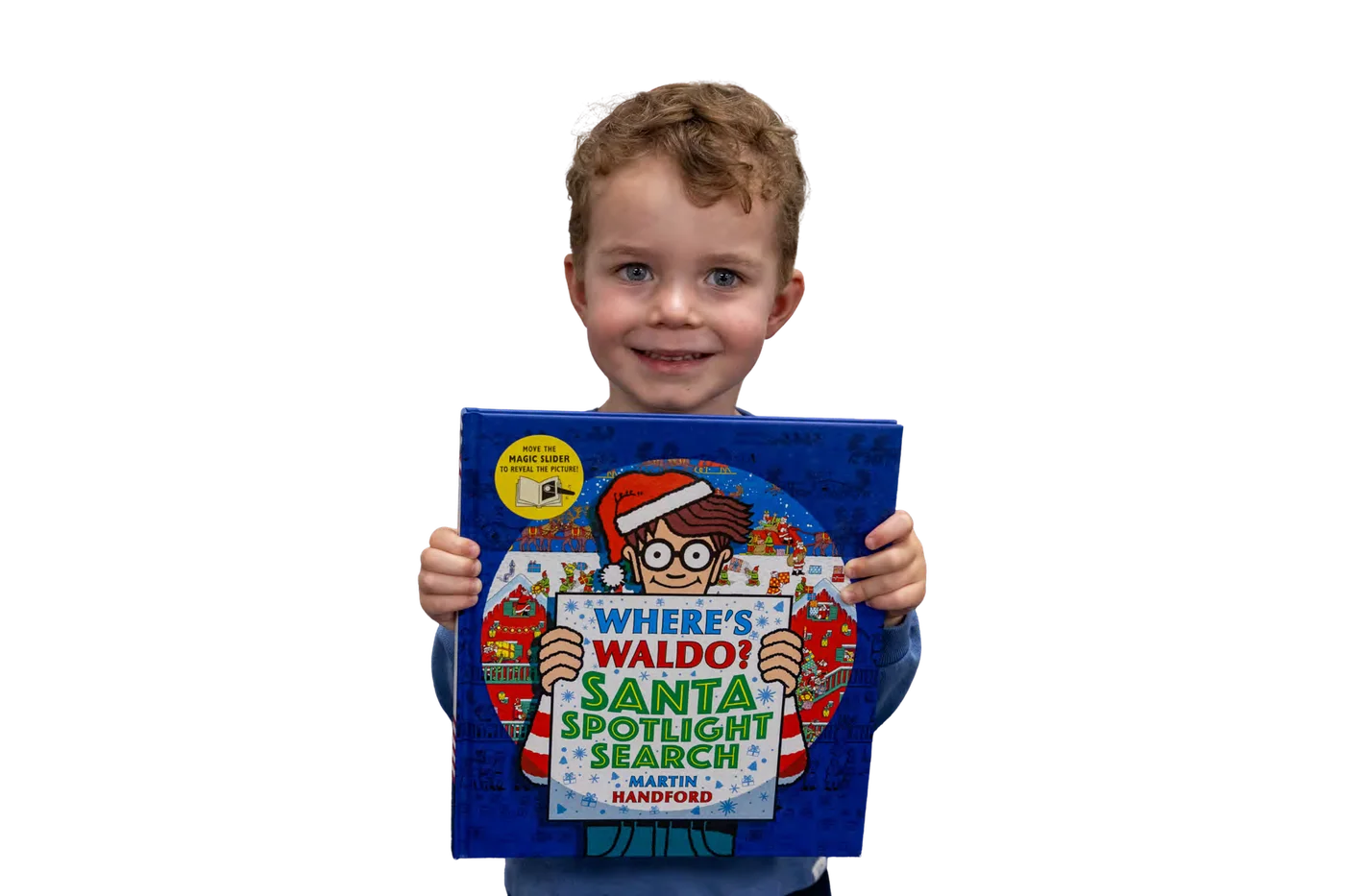 A smiling boy holding up a picture book