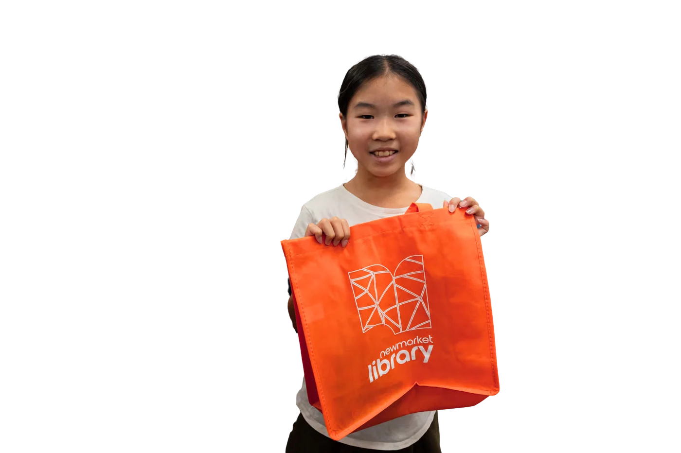 A girl proudly holding an orange Newmarket Library tote bag
